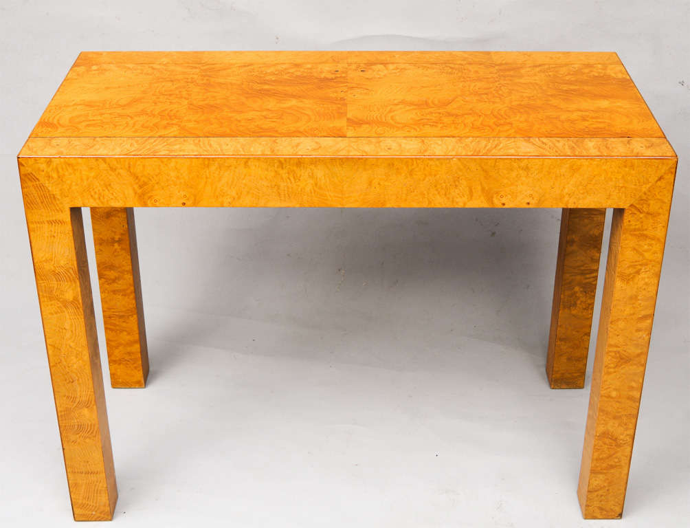 Dining room table, able to seat eight, of olivewood burl veneer, having three removable leaves, collapsible into a Parson's style console table.  