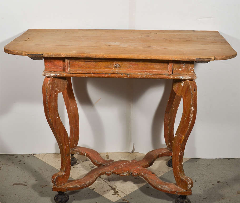 Handsome Swedish baroque table, circa 1760. Original red paint and scraped top to expose the natural wood. Sitting on four beautiful black bun feet.