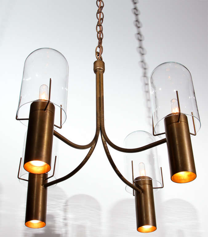 Stuart Barnes for Robert Long four arm chandelier in bronze with glass hurricanes.  
  