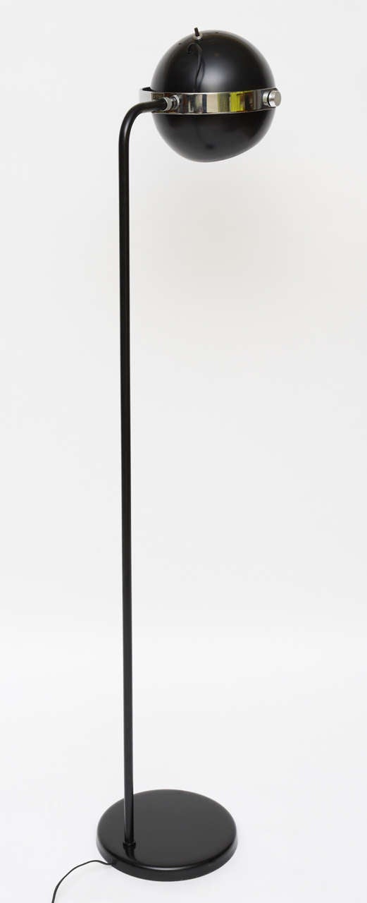 ....SOLD...  Designed by Robert Sonneman, this ball head floor lamp in black has a adjustable head floating in a chrome curved bar holder.  Takes medium base bulb or reflector, 75 watts max.  Excellent original condition.

Dimensions 10