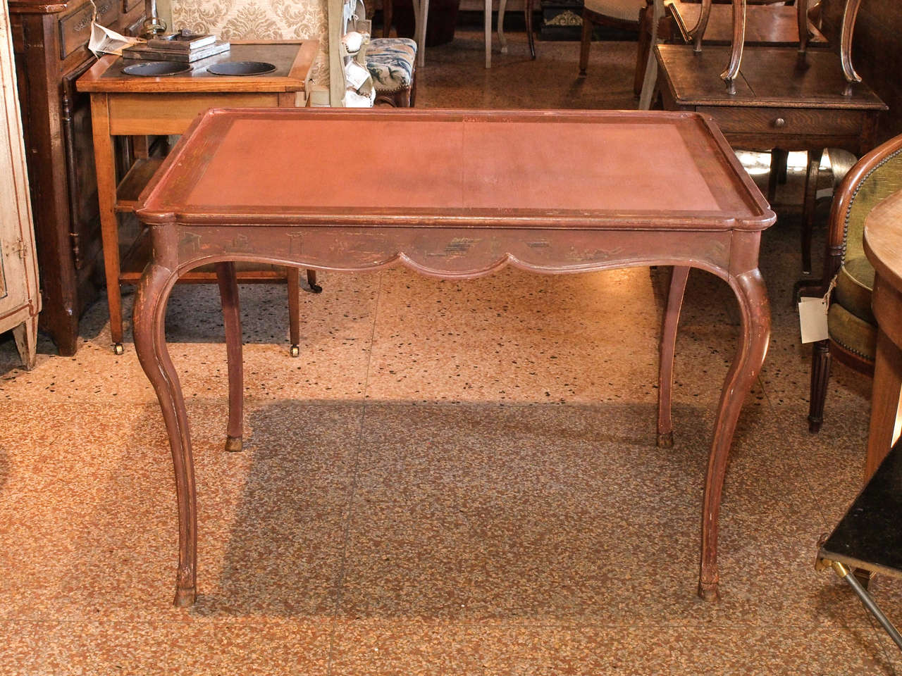 Circa 1920, the top of the table is banded with a gold chinese border. The skirt and cabriole legs have faint decorative chinese motifs in the Jansen style
