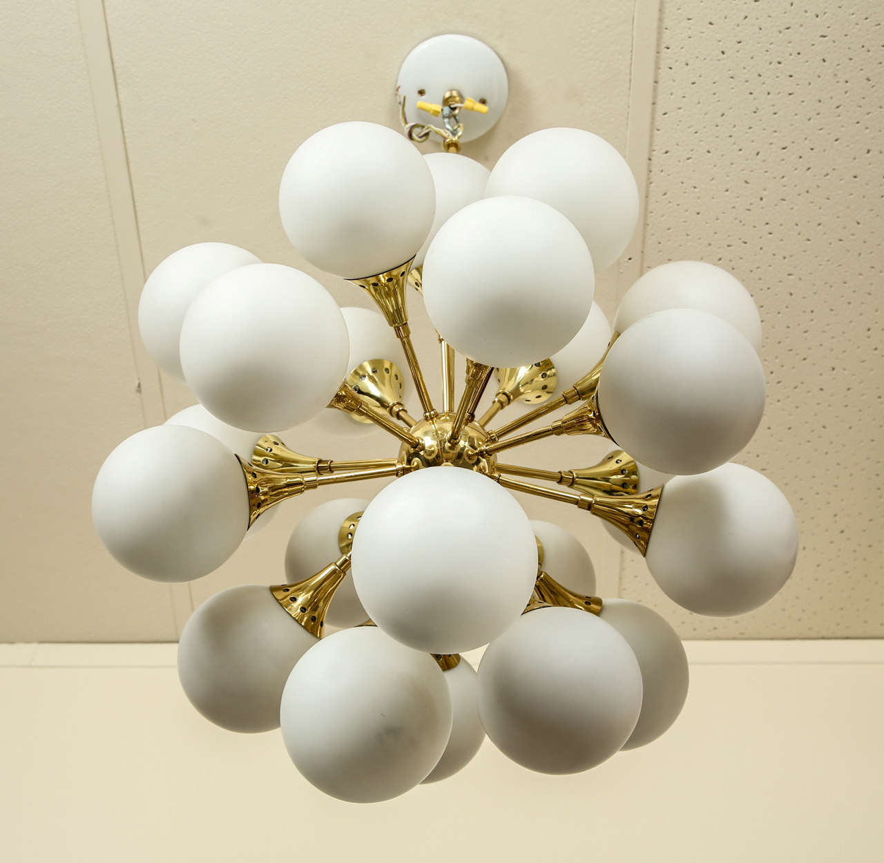 Brass Fabulous brass sputnik chandelier with frosted glass globes.