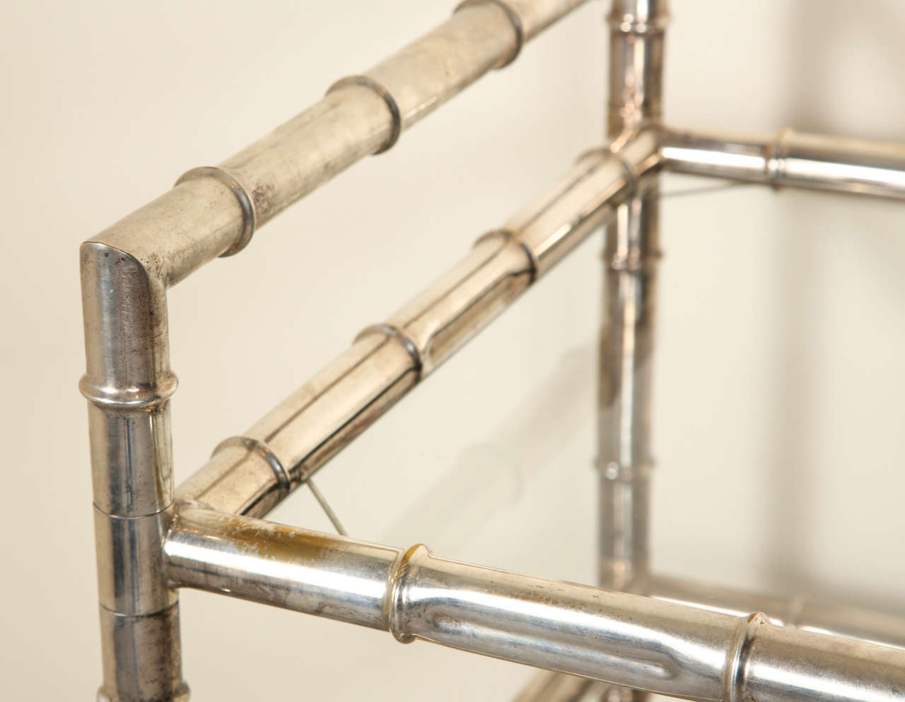 Nickel plated Bamboo style Bar Cart with glass shelves on casters.