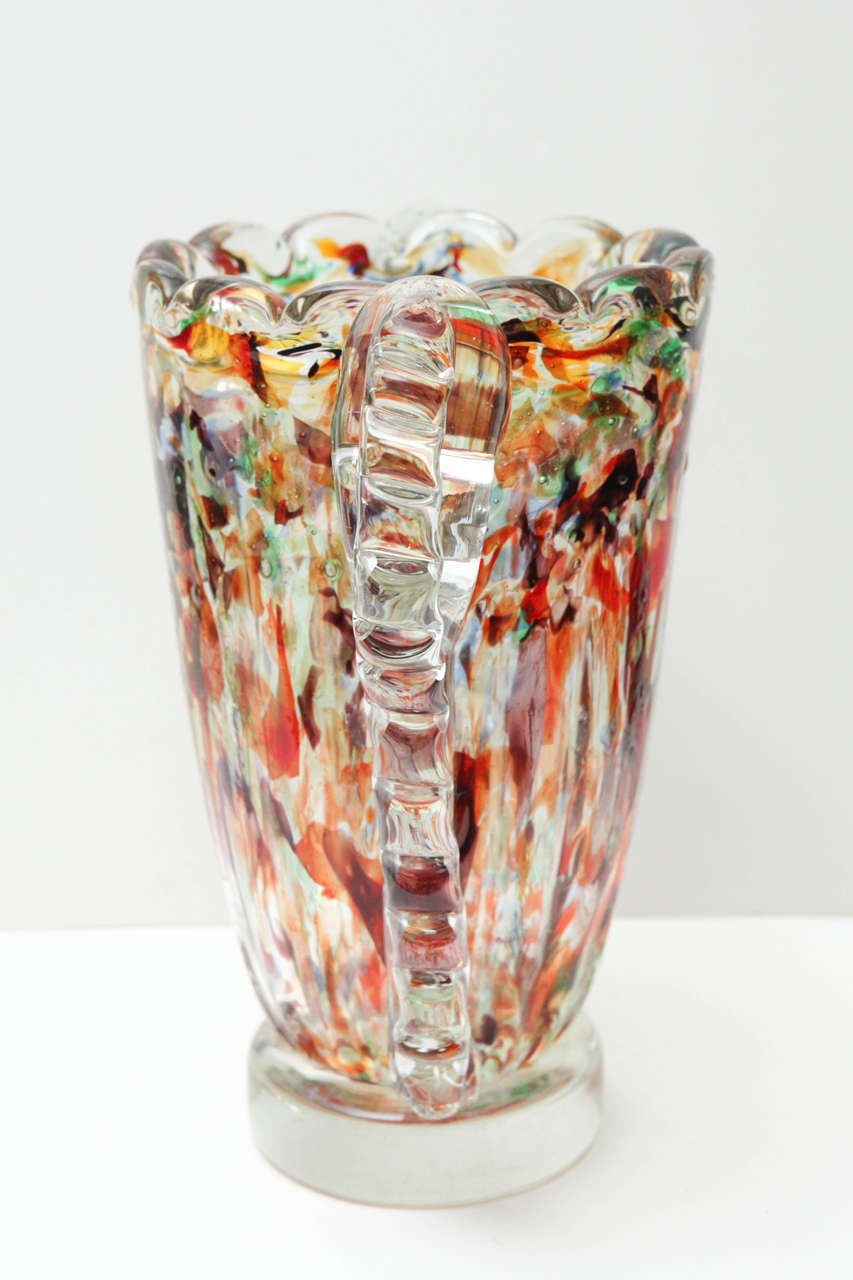 Large scalloped vase with scalloped handles. Centre is multicolored white the handles and base remain clear. Believed to be Murano glass.
