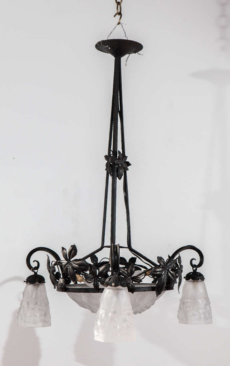 French iron chandelier newly rewired for six candelabra bulbs. The large glass shade is signed Ros.
