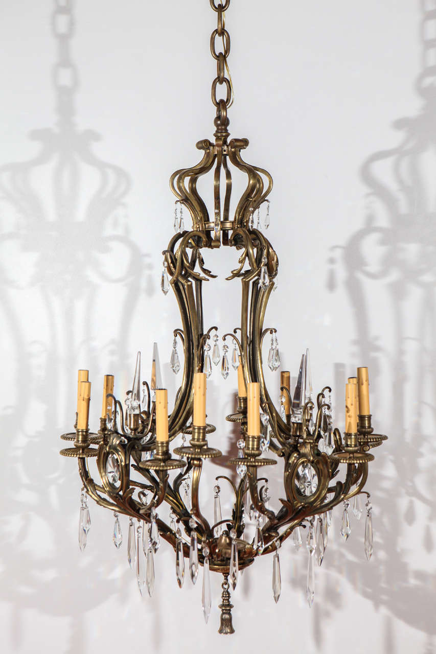 Graceful bronze chandelier with crystals, newly rewired for 12 candelabra bulbs.