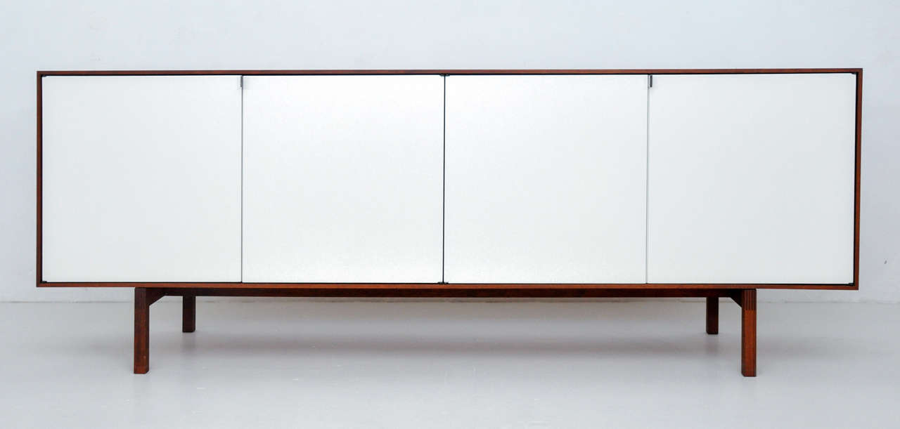 Florence Knoll sideboard. Walnut case with satin white lacquer doors.