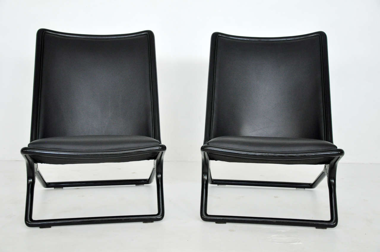 Scissor chairs designed by Ward Bennett for Brickel. Ebonized ashwood frames with smooth black leather upholstery.