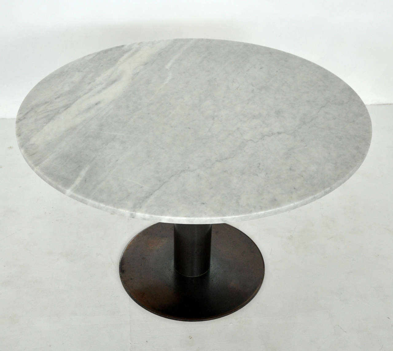 Marble dining table with bronze base. Designed by Nicos Zographos.