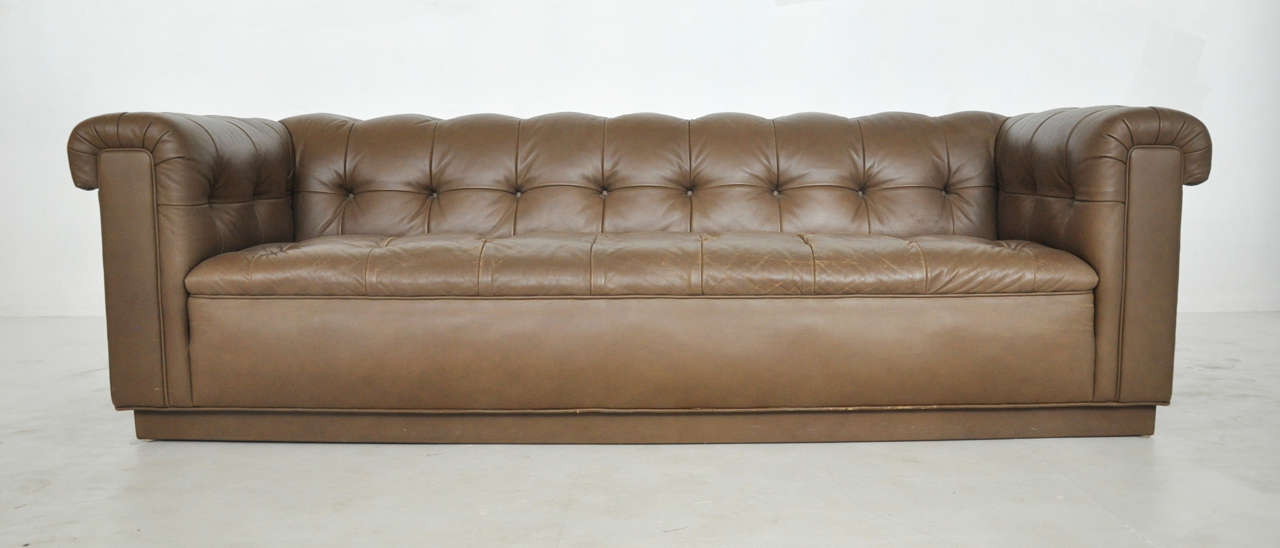 1960s Chesterfield sofa by Ward Bennett for Brickell. Original brown leather. Wide arms and back designed to provide extra seating for conversation.