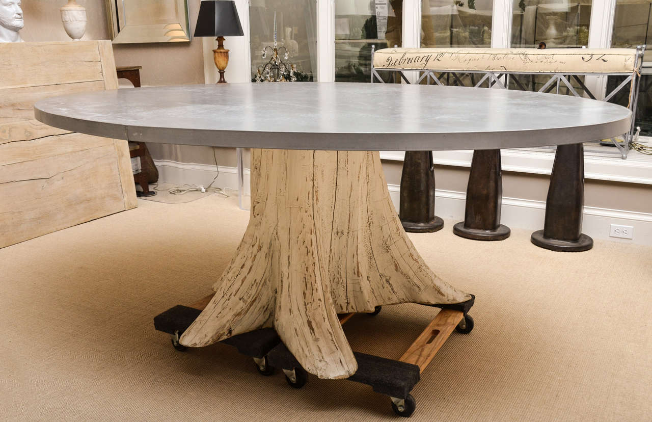 Natural one-of-a-kind tree trunk dining table. The trunk has been white washed. The top is oval and zinc.