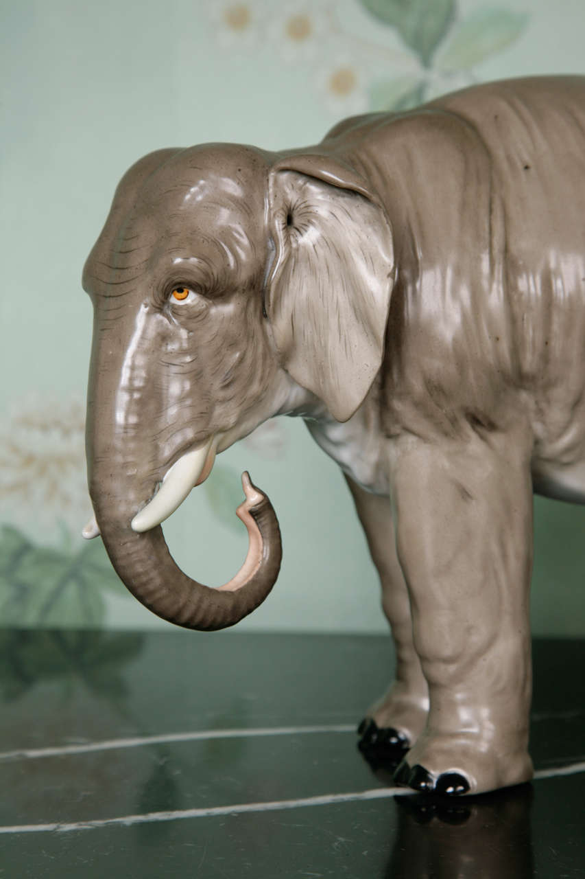 A rare pair of finely modelled grey porcelain elephants each standing with left foot forward, trunks curled beneath tusks, the features realistically picked out in colours, each with impressed stamps under the front feet. Elbogen. These elephants