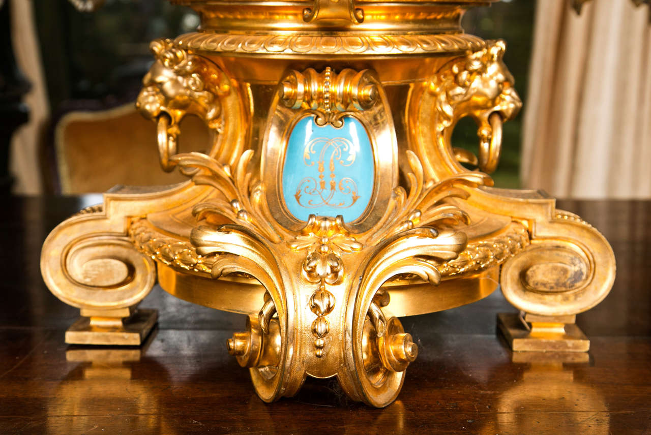 A baluster shaped 17/18th c. Imari vase of large  size with gilt bronze top and base.  The  19th century base in Louis  XV style with scrolling feet, lion masks with rings, foliates and a central turquoise  enamel with initials in gold. The   vase