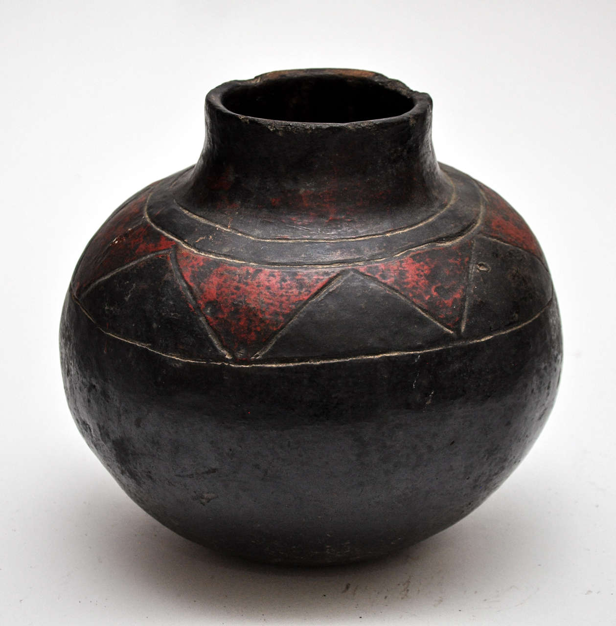 This is a pot made in Southern Africa by the Shona peoples. The pots are typically used to carry beer during spiritual ceremonies. They are crafted from clay, shaped and decorated by hand and small tools, and then fired in a kiln.

Diameter at