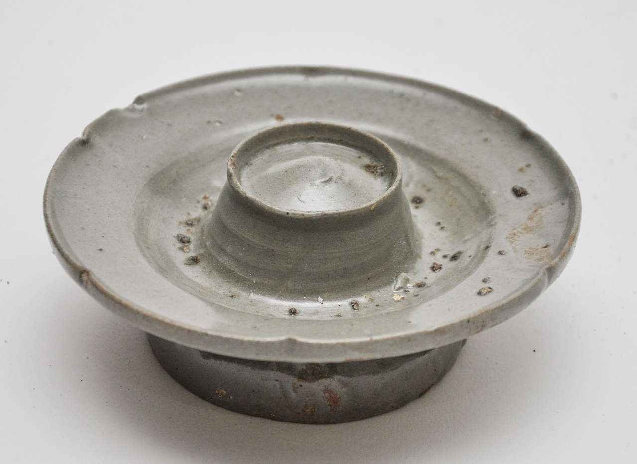 This is a very rare 19th century Korean candle holder in a gray glaze.