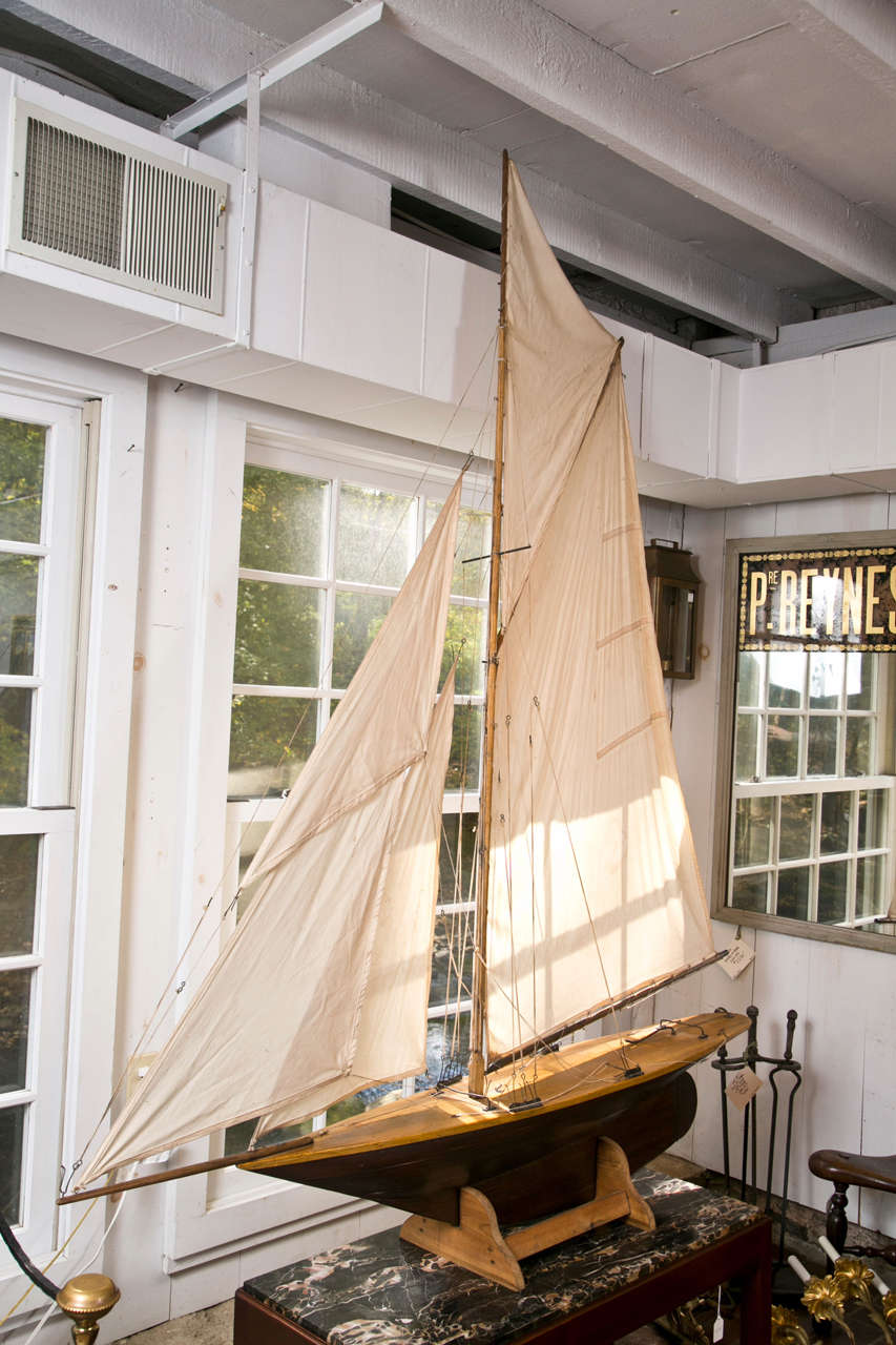 This very large and elegant yacht was built for pond racing, but looks just as well sunning itself in a large window. After gaining popularity in the late 19th century, this type of model boat racing has continued to this day. Well-proportioned,