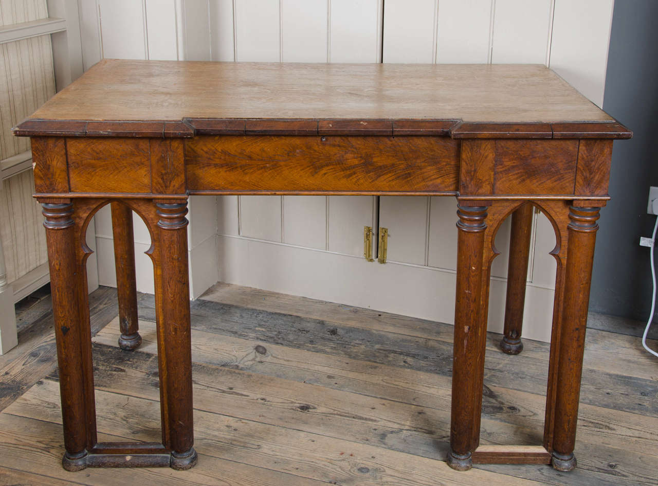 Of inverted breakfront form with parquetry moulded top above a plain frieze on arcaded turned legs.
