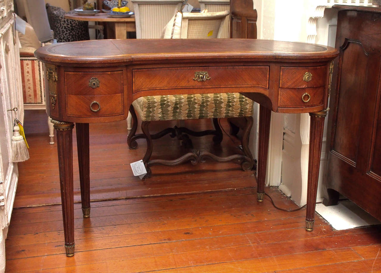 19th century walnut and leather top desk with one main drawer and two on each side.