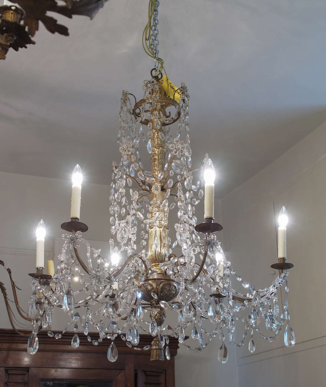 19th century Italian crystal chandelier bearing six iron arms with tole bobeches and a carved wood gilded body.
US wired.