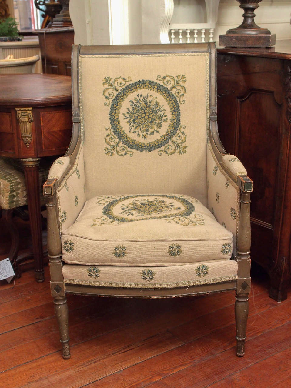 Set of four 19th century painted Directoire style bergeres upholstered in tapestry type petti point.
