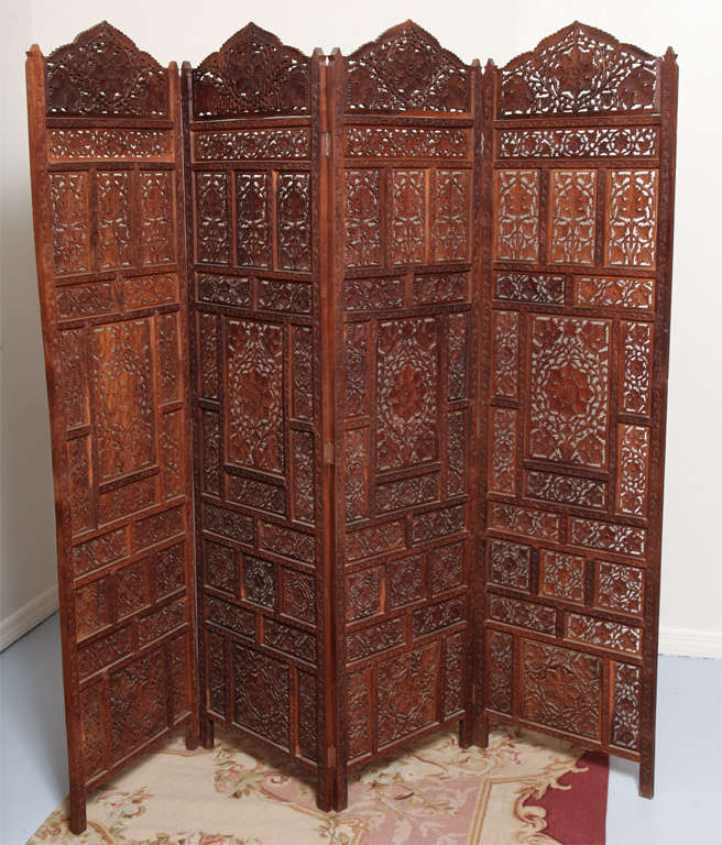 Lovely pair of four panel screens in natural Teak wood finish. Each panel measures 20 inches by 75 inches.