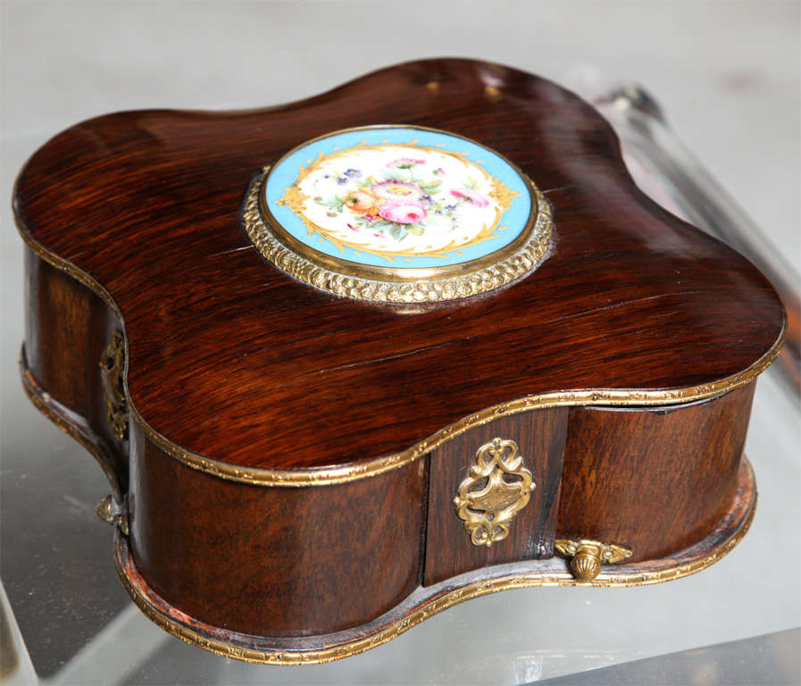 Exquisite rosewood jewelry box with bronze ormolu fittings and topped with a beautiful Sevres plaque.