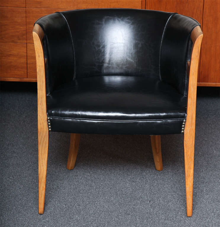 ...SOLD...Channeling Danish Master Kaare Klint's Faaborg chair, this leather with bronze nailhead upholstered barrel chair is quite nice.  From all angles it is delectable...a wonderful profile, elegant and smart from the saber back legs to the
