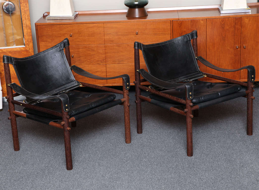 ...SOLD FEBRUARY 2012...Actually lounge chairs, these black saddle leather and Brazilian rosewood chairs by Arne Norell (1917-1971) are exceptional beauties.  The design, inspired by Klaare Klint's Safari chair from 1933, is a wonderful sling
