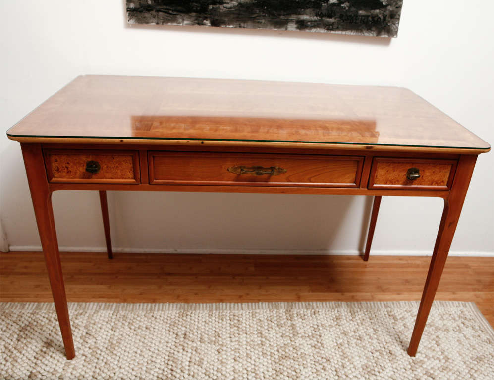 With tapered legs, original metal pulls, lined drawers, and a burlwood front on the drawers to either side of the center drawer, this Lane desk (made in Altavista, CA) is elegant while being compact enough for smaller spaces. We've included a piece
