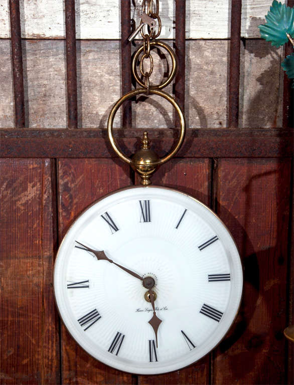Porcelain and brass wind up pocket watch wall clock with large brass chain.