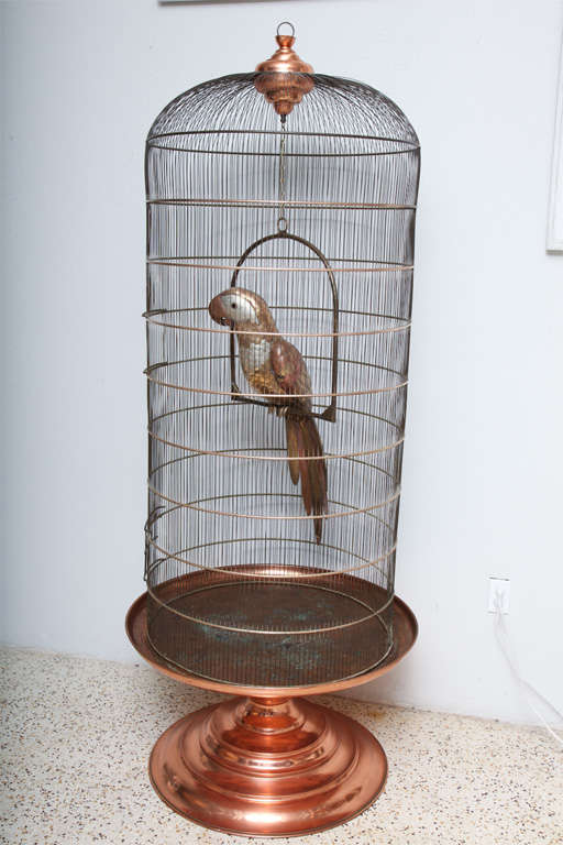 Created by hand in brass, copper, and tin, this beautifully crafted parrot by Mexican folk artist Sergio Bustamante comes in its own (enormous) original, brass and copper cage... An outstanding piece!