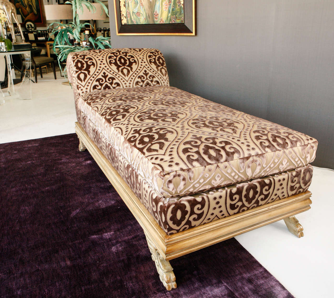A luxurious Regency chaise longue upholstered in a dusty plum cut silk velvet.  This chaise retains its original antiqued painted finish. The base is detailed with scroll details and winged pad feet.