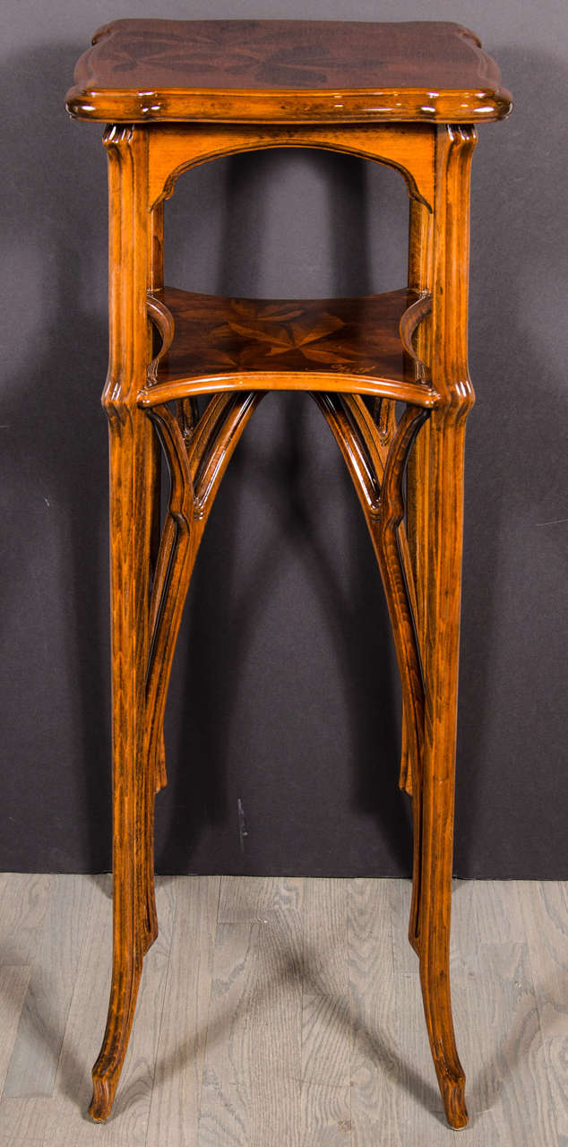 Exquisite Art Nouveau Marquetry pedestal table with exotic mahogany inlay signed by Emile Galle. Sinuous design throughout, this ethereal feeling table features hand inlay of exotic woods depicting stylized leaf designs in different shaded tones,