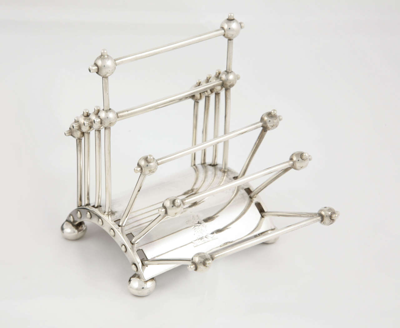 This is a rare Victorian sterling silver toast rack which as the photographs show, is designed to collapse inwards in a concertina manner. It is from a design made famous by Dr.Christopher Dresser and is of the period, with hallmarks for London