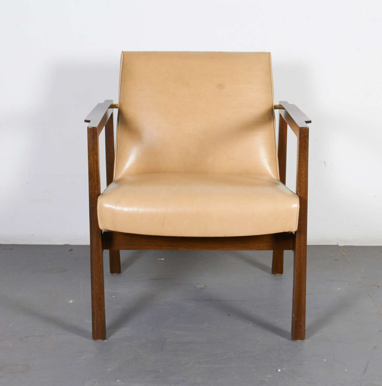 A modernist pair of leather and mahogany armchairs by Edward Wormley for Dunbar; American late 50's.