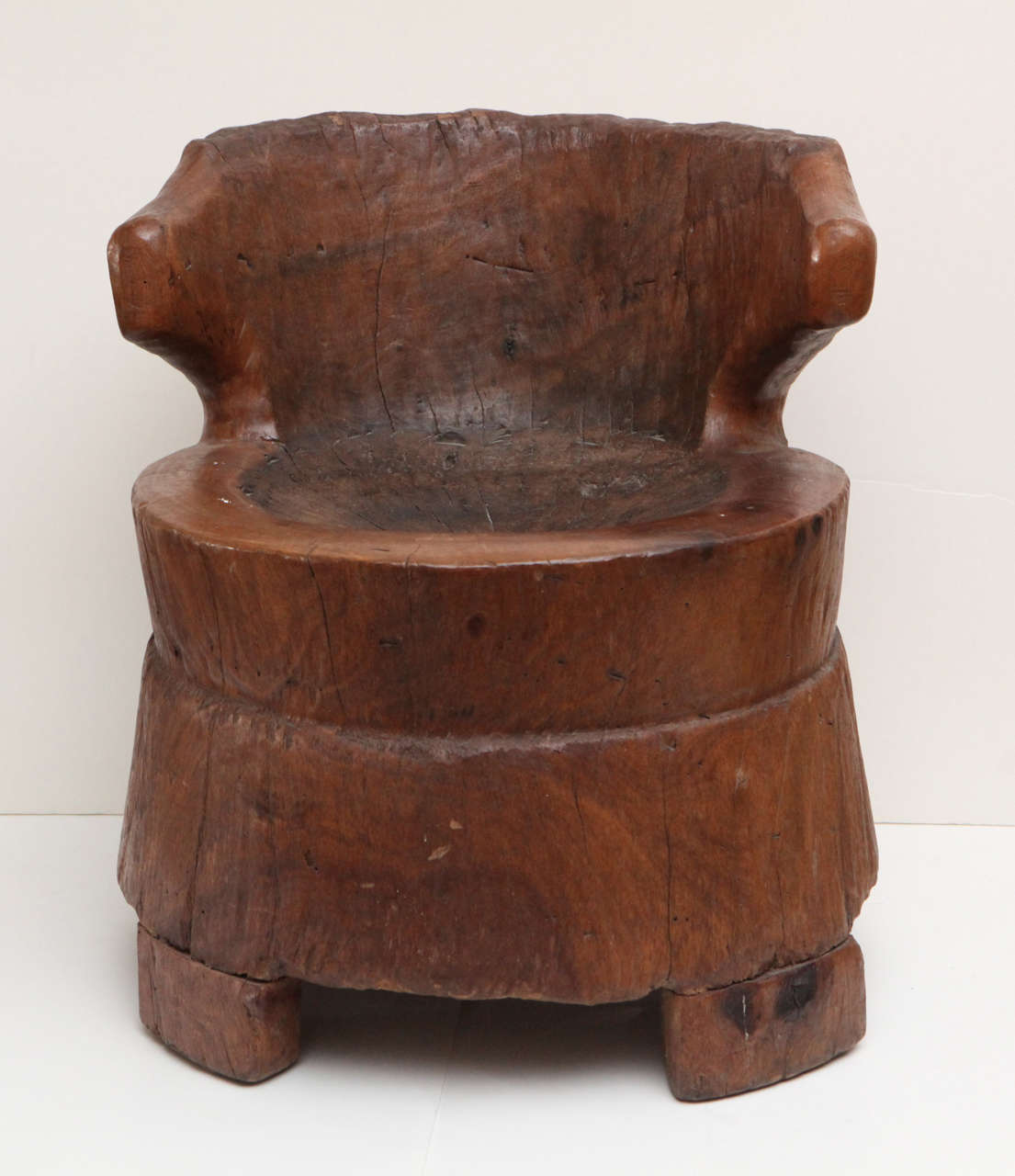Pair of hand carved tree stumps African chairs, perfect for sitting and holding space, decoratively or functionally. They're size's are slightly different in form (see apron and legs). Perfect balance of design for a modern stark setting.