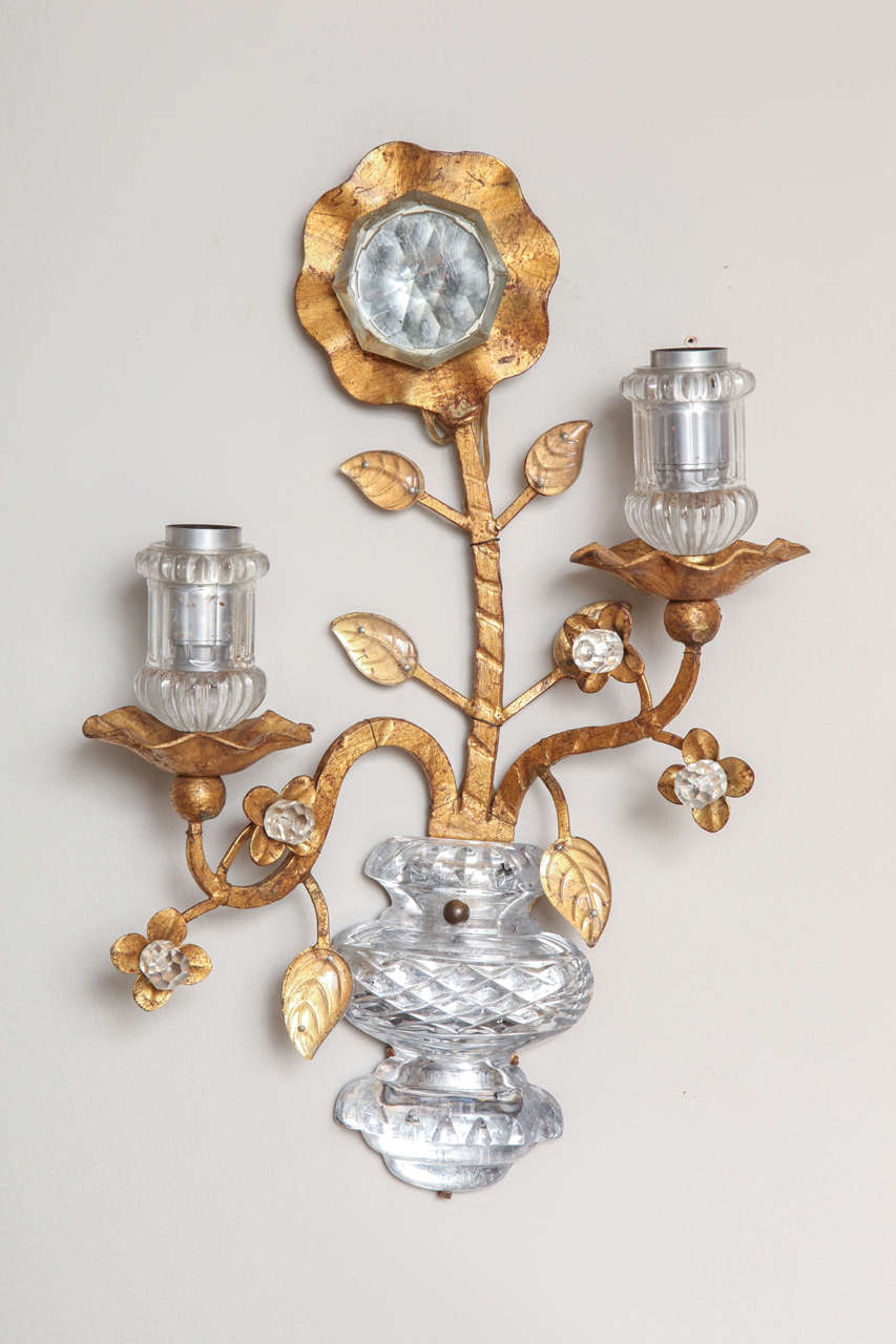 A pair of right and left facing gilt metal sconces. The design featuring oversized flower with molded glass face with crystal leaves issuing from vase shaped backplate with molded glass face by the Italian firm Banci Firenze.