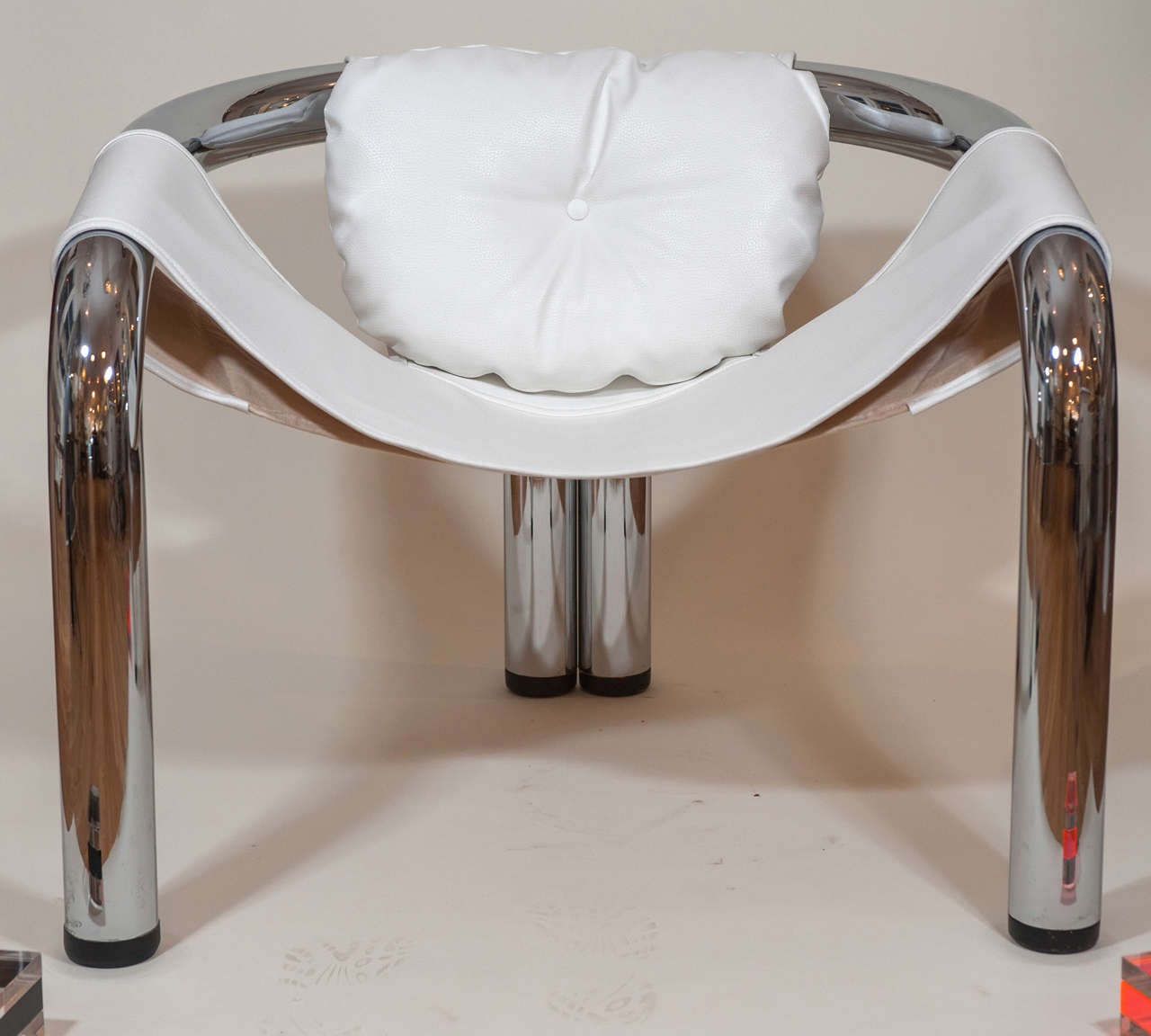 A cool 1970's chrome sling chair in new faux leather upholstery.