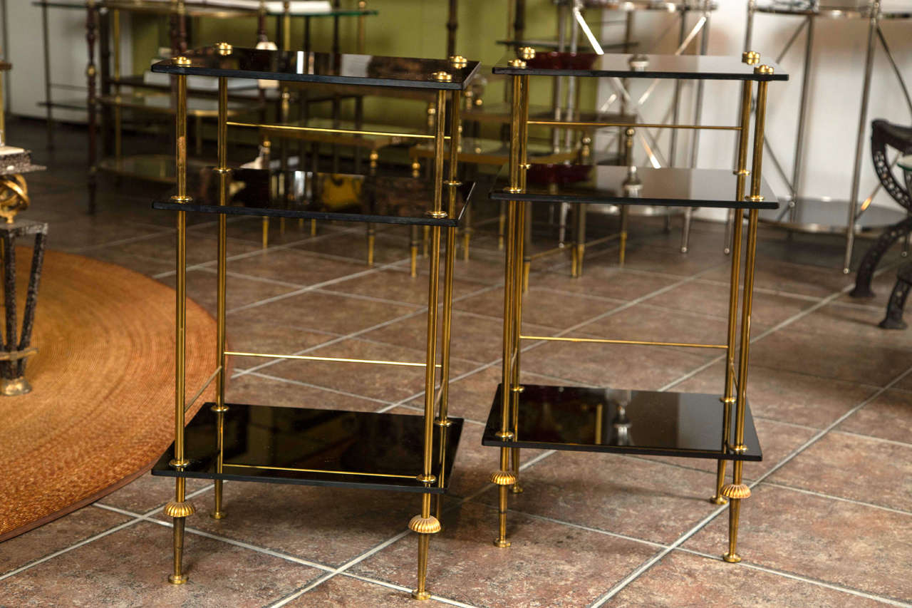 Pair of Italian black glass and bronze three-tier end tables.