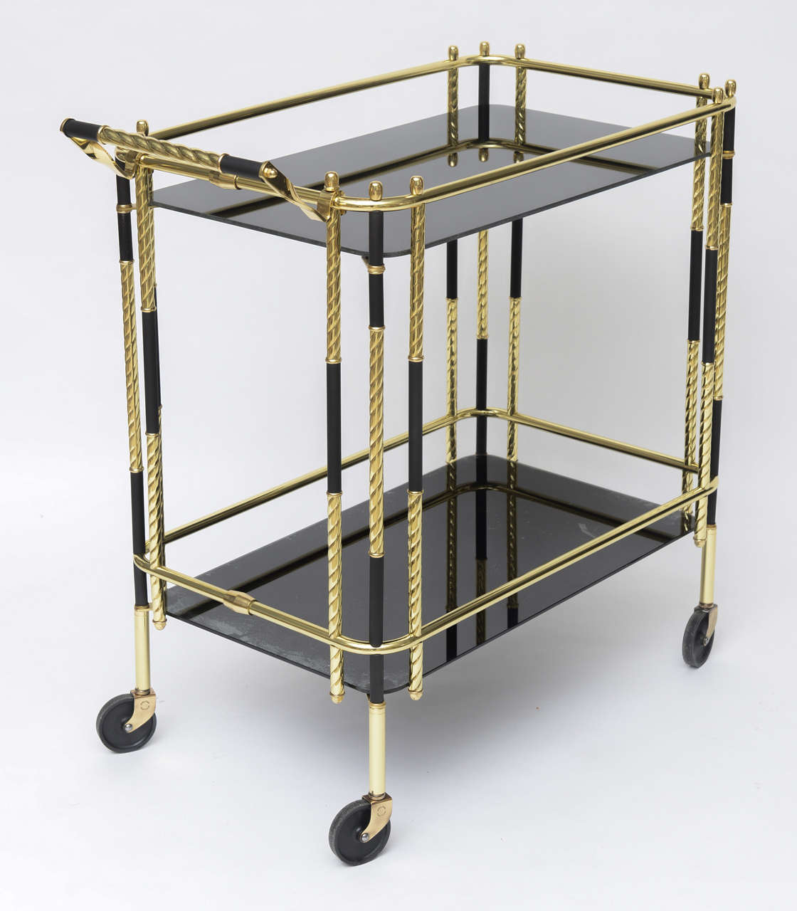 Polished brass bar cart with black accents and black glass shelves. Professionally polished.