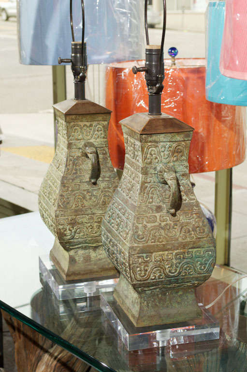 Beautiful pair of Antique Asian (Thai) Bronze Jars made into Lamps with new plexiglass bases and antiqued hardware.