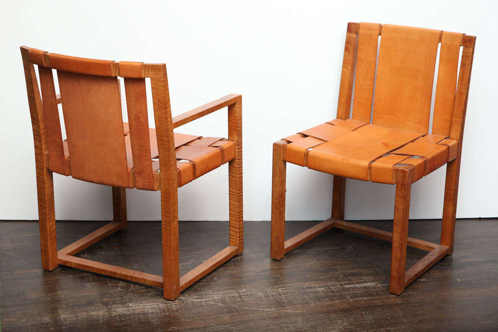 Super chic pair of chairs comprised of highly-figured tiger maple frames.  Wide-band leather strapping with great patina.  This design shows up in several of Gibbings' interiors from the 1940's.