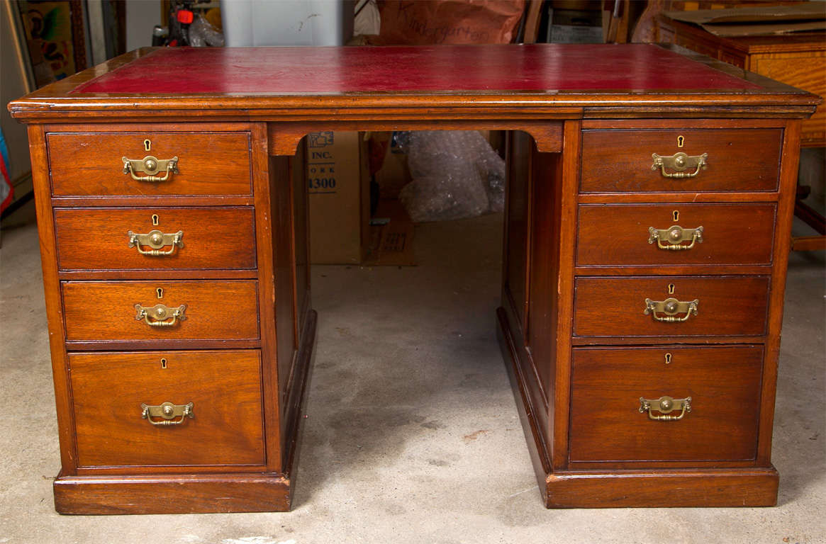 Mahogany red leather top partners desk.  Drawers on both sides.  Locks in each drawer.