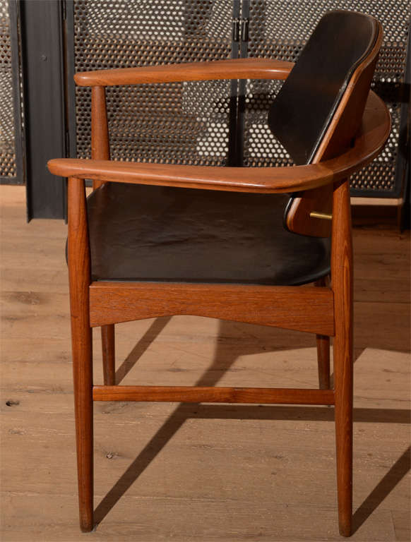 Pair of beautifully crafted 1950's Ib Kofod Larsen chairs with original black leather upholstery