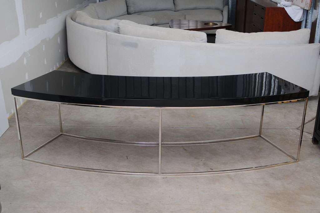 A Pair of Bow Sofa Tables designed by Milo Baughman to fit behind the round sectional sofa by the same designer and listed separately.
The composite tops with high gloss lacquer finish are supported by a very light
Steel frame in mirror nickel