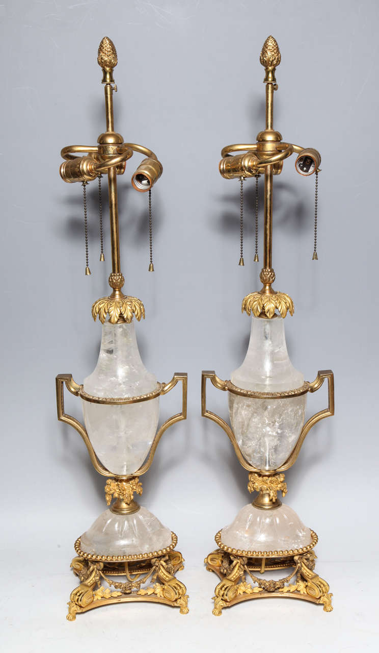A pair of superb antique French Louis XVI  gilt bonze mounted cut rock crystal urn form lamps of fine detail embellished with floral wreaths,19th century