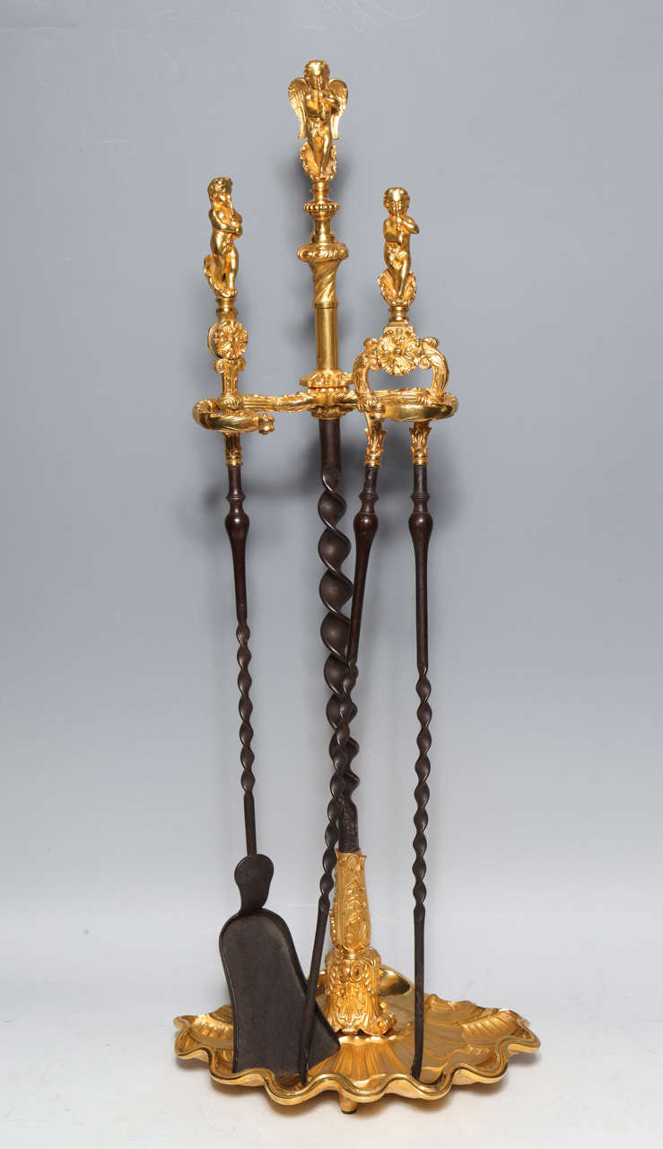 A fine antique American Louis XVI style gilt bronze figural fire place tool set, attributed to E. F. Caldwell, New York. A complete set, very finely hand chiseled bronze and detailed, with cherubs and cupids playing musical instruments, all raised