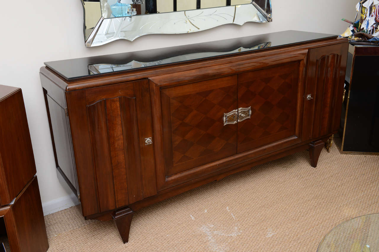 Very fine French Art Deco sideboard. Created with at least five different types of exotic hardwoods from Madagascar, Brasil and Indonesia. Bronze hardware is nickel-plated. Inverse piramid legs. Featuring a black glass top. Recently restored.
