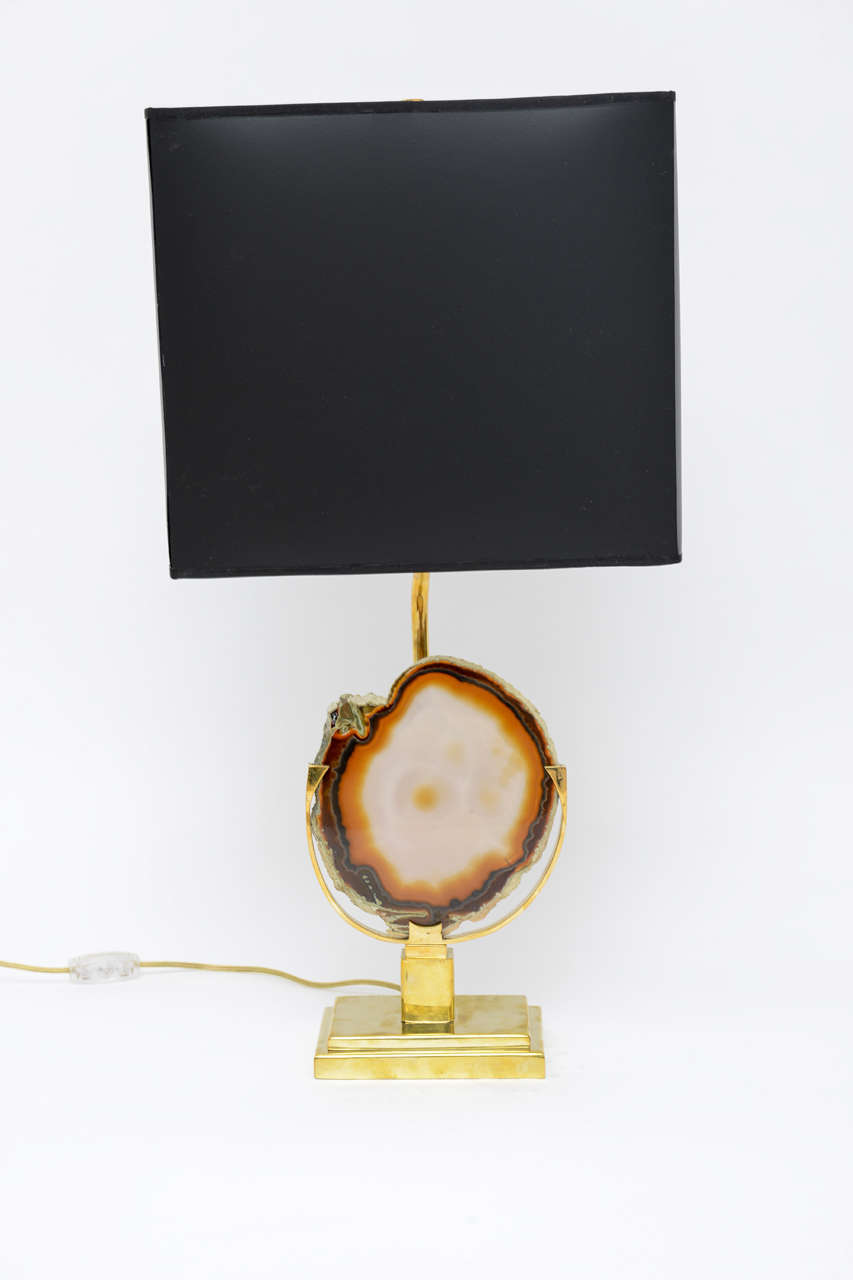 Table lamp in the style of Willy Daro. Brass base displaying a finely polished agate. Shade not included.
