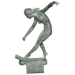 A patinated bronze figure of a nude water skiing